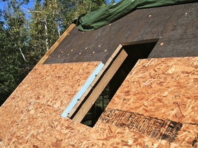 This roof is being insulated from the top using rigid sheets of extruded polystyrene foam. It allows the roof boards and rafters to remain visible from inside when maximum insulation levels are not needed.