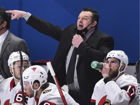 Head coach of the Ottawa Senators D. J. Smith pulls down his mask to call out instructions against the Montreal Canadiens during the third period at the Bell Centre on February 4, 2021 in Montreal, Canada.