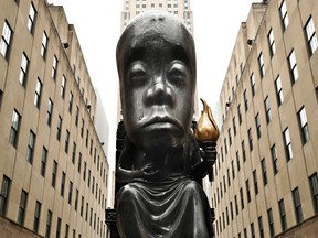 A 25 foot bronze sculpture titled 'Oracle' by artist Sanford Biggers is unveiled at the Fifth Avenue entrance to the Channel Gardens at Rockefeller Center on May 05, 2021 in New York City.