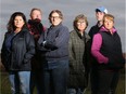 Ace Powell (red jacket) and his wife Michelle (far left), along with their neighbours (from left: Teddie Laframboise, Pat Gillis, Austin Hutt and Casey Gillis) stand at the end of Powell's property in North Gower.