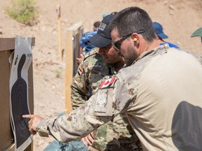 This 2019 file photo shows a Canadian Forces member at a U.S. base near Mosul teaching combat skills to Iraqi Wide Area Security Forces.