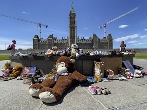OTTAWA -- Residential Schools Memorial of shoes at the Centennial Flame on Parliament Hill , in memory of the 215 children whose remains were found at the grounds of the former Kamloops Indian Residential School in Kamloops, B.C. Monday, May. 31, 2021.
