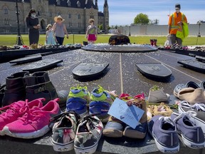 The Residential Schools Memorial of shoes at the Centennial Flame on Parliament Hill on May 31, 2021.