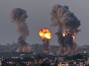 Smoke and a ball of fire rise above buildings in Khan Yunis in the southern Gaza Strip, during an Israeli air strike, on May 12