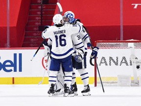 Toronto Maple Leafs forward Mitchell Marner (16) celebrates the shutout win against the Montreal Canadiens with teammate goalie Jack Campbell (36) during the third period in game four of the first round of the 2021 Stanley Cup Playoffs at Bell Centre.