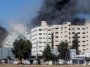 Gaza tower housing AP, Al Jazeera collapses after missile strike in Gaza city, May 15, 2021.