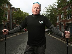 Michael Baine poses for photo in front of his house in Ottawa Wednesday. Michael has stage four prostate cancer that has spread to his bones and hips. Despite that, he's walking 21 kilometres as part of Ottawa Race Weekend to raise money for The Ottawa Hospital Cancer Centre.