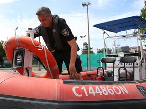 Constable TJ Jellinek of the Ottawa Police's marine, dive and trails unit with one of the unit's boats at the Britannia Yacht Club.