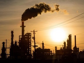 (FILES) In this file photo taken on April 21, 2020, the sun sets behind smoke rising from the LyondellBasell-Houston Refining plant in Houston, Texas. (Photo by MARK FELIX/AFP /AFP via Getty Images)