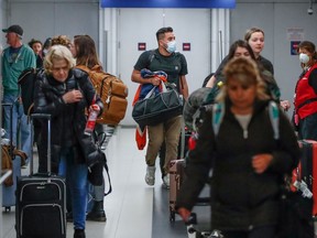 (FILES) In this file photo taken on March 15, 2020, travelers arrive at the international terminal of the O'Hare Airport in Chicago, Illinois.