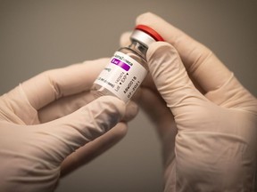 A pharmacist holds a vial of the AstraZeneca COVID-19 vaccine. Some people are now confused about getting their second shot.