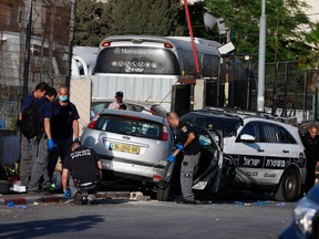 An Israeli security forces inspect on May 16, 2021 the scene of a car-ramming attack which wounded several people, including four police officers, in the flashpoint Sheikh Jarrah neighbourhood of Israeli-annexed east Jerusalem.