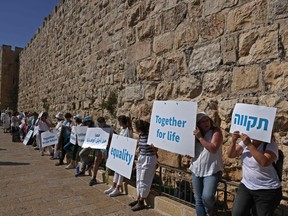 Members of Women Wage Peace, an Israeli grassroots peace movement, take part in a rally calling for coexistence and an end to the Israeli-Palestinian conflict, along Jerusalem's Old City walls, on May 19.