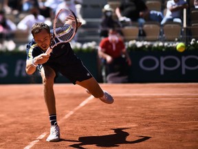 Russia's Daniil Medvedev returns the ball to Kazakhstan's Alexander Bublik during their men's singles first round tennis match on Day 2 of The Roland Garros 2021 French Open tennis tournament in Paris on May 31, 2021. (Photo by Anne-Christine POUJOULAT / AFP)