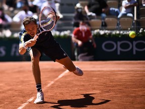 Russia's Daniil Medvedev returns the ball to Kazakhstan's Alexander Bublik during their men's singles first round tennis match on Day 2 of The Roland Garros 2021 French Open tennis tournament in Paris on May 31, 2021.