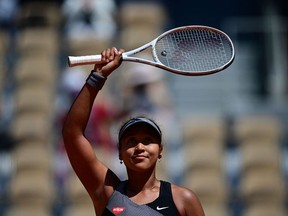 (FILES) In this file photograph taken on May 30, 2021, Japan's Naomi Osaka celebrates after winning against Romania's Patricia Maria Tig during their women's singles first round tennis match on Day 1 of The Roland Garros 2021 French Open tennis tournament in Paris. - Naomi Osaka said May 31, 2021, that she is withdrawing from the French Open following the bitter fall-out from her decision to boycott all media activity.