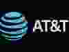 FILE PHOTO: The company logo for AT&T is displayed on a screen on the floor at the New York Stock Exchange (NYSE) in New York, U.S.. REUTERS/Brendan McDermid/File Photo