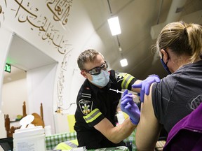 Peel Region Paramedic Ryan Kingsborough, administers a dose of the Moderna COVID-19 vaccine, at a one-day pop-up vaccination clinic in Mississauga, Ont., on Thursday, April 29, 2021.