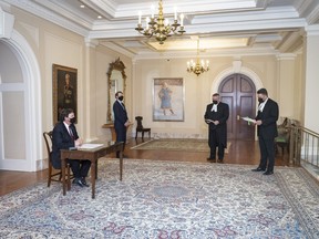 In this March 31 photo, Richard Wagner, the Administrator of the Government of Canada, attends a socially distanced signing ceremony at Rideau Hall for two new bills.