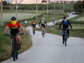 People bike at dawn on the outskirts of Ronda, Spain in May 2020.