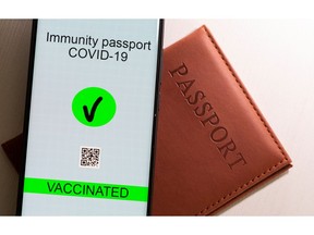 A smartphone with displayed "Immunity passport COVID-19" is placed on a passport in this illustration taken April 27, 2021.