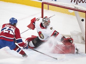 Montreal Canadiens' Cole Caufield scores against Ottawa Senators' goaltender Filip Gustavsson during overtime NHL hockey action in Montreal, Saturday, May 1, 2021.