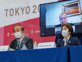 Tokyo 2020 CEO Toshiro Muto, Tokyo 2020 President Seiko Hashimoto and IOC Coordination Commission Chairman John Coates remotely on-screen attend an International Olympic Committee (IOC) and Tokyo 2020 Olympic news conference after a three-day IOC Coordination Commission meeting, in Tokyo, Japan, May 21, 2021.  Nicolas Datiche/Pool via REUTERS
