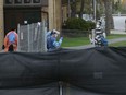 Staff talk outside Le Patro d'Ottawa on Cobourg Street on Tuesday.