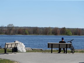 OTTAWA - May 12 2021 - A biker enjoys the scenery while social distancing on Petrie Island in Ottawa Wednesday.  TONY CALDWELL, Postmedia.