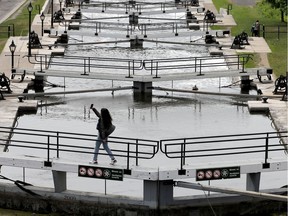 A woman takes a selfie while crossing the locks on the Rideau Canal in Ottawa Friday.
