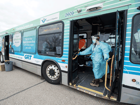 Health-care workers conduct rapid COVID-19 screening on a city bus in the Waterloo Region Friday. The rollout of rapid testing in Canada has been slow, but that is changing.