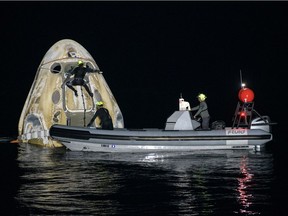 Support teams work around the SpaceX Crew Dragon Resilience spacecraft shortly after it landed with NASA astronauts Mike Hopkins, Shannon Walker, and Victor Glover, and Japan Aerospace Exploration Agency (JAXA) astronaut Soichi Noguchi aboard in the Gulf of Mexico off the coast of Panama City, Florida, U.S. May 2, 2021.