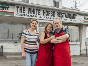 Malack Bahoo, left, an employee at the restaurant, Mike and Rachel Ayoub, owners of The White Horse Restaurant in Ottawa are photographed in front of their restaurant before its doors closed.