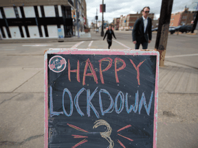 A sidewalk sign reflects some of the frustration of Calgarians amid the latest COVID restrictions. Alberta had the highest percentage of people who responded in a poll that they've lost trust in the federal and provincial governments.