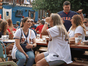 People drink and eat at Truck Yard beer garden in Houston in early April. While some Canadian provinces are struggling with lockdowns, Texas did away with most COVID restrictions in March.