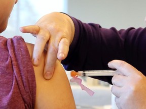 A person receives a COVID-19 vaccine.