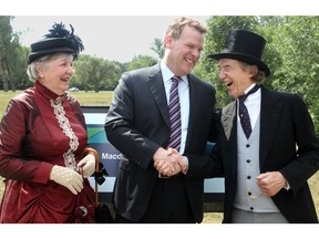 Then-Foreign Minister John Baird poses with historical impersonators representing John A. and Agnes Macdonald, at the August 2012 ceremony at which the Ottawa River Parkway was renamed in Macdonald's honour.