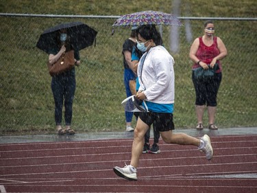 A quick downpour sent volunteers and organizers running quickly to get tents and everything sorted to keep the vaccine rollout moving on schedule.