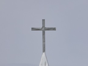 FILE: The steeple cross on a church.
