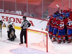 Canadiens players celebrate Artturi Lehkonen's overtime goal as Golden Knights goalie Robin Lehner can only look on in disappointment at the Bell Centre Thursday night.