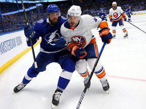Erik Cernak #81 of the Tampa Bay Lightning and Jean-Gabriel Pageau #44 of the New York Islanders battle along the boards during the second period in Game One of the Stanley Cup Semifinals during the 2021 Stanley Cup Playoffs.