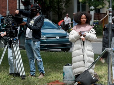 Here, co-stars Bresha Webb (left) and Getenesh Berhe chat as cameras get set up for a scene.
