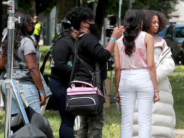 Here, co-stars Bresha Webb (far right) and Getenesh Berhe (second from right) get tended to by a hair and makeup team before shooting a scene.