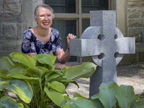 Rev. Karen Dimock of St. Andrew's Presbyterian Church with the Celtic cross that was donated by a Good Samaritan after the previous one was stolen from the church's garden in April.