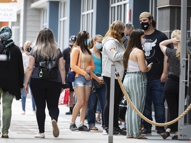 OTTAWA -- Shoppers line up to enter a store at the Tanger Outlets on the first day of Stage 1 of the provincial reopening on Friday, Jun. 11, 2021 -- . ERROL MCGIHON, Postmedia