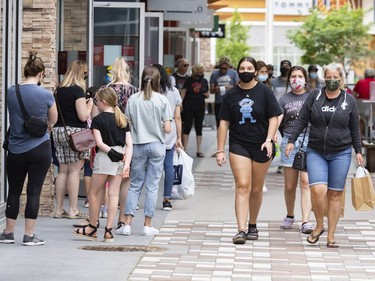 OTTAWA -- Shoppers line up to enter a store at the Tanger Outlets on the first day of Stage 1 of the provincial reopening on Friday, Jun. 11, 2021 -- . ERROL MCGIHON, Postmedia