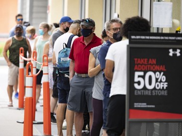 Shoppers line up to enter a store at the Tanger Outlets on the first day of Stage 1 of the provincial reopening on Friday, Jun. 11, 2021
