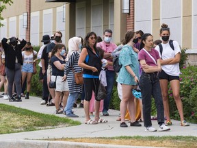 Shoppers lined up around the building to shop at a Value Village store on Hazeldean Road on the first day of Stage 1 of the provincial reopening on Friday, Jun. 11, 2021.