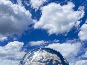 OTTAWA -- The sky is reflected in one of two spheres by artist Kenneth Emig that adorn the Adawe Crossing Bridge, joining Strathcona and Riverain Parks. Monday, Jun. 28, 2021.