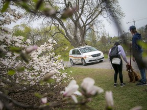 People stroll through the Arboretum, part of the Central Experimental Farm, Sunday, April 25, 2021.